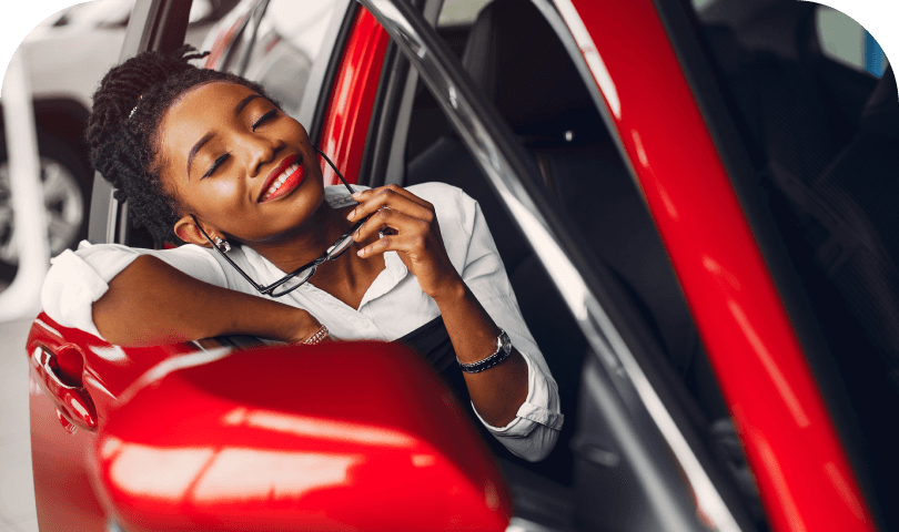 Driver leaning out of a red car
