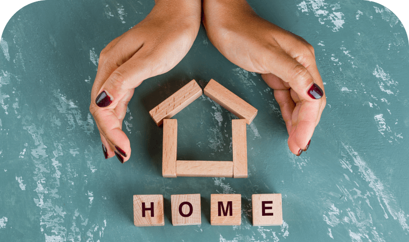 Hands arranging blocks spelling home